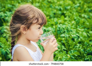 Child Glass Of Water. Selective Focus.