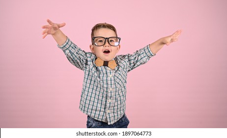 Child With Glasses, On A Pink Background. High Quality Photo