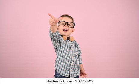 Child With Glasses, On A Pink Background. High Quality Photo