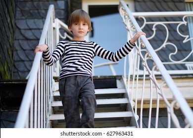 The child goes down the metal stairs