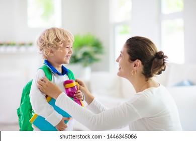 Child Going Back To School. Mother And Kid Getting Ready For First School Day After Vacation. Little Boy And Mom Going To Kindergarten Or Preschool. Student Packing Books, Apple And Lunch In Backpack.