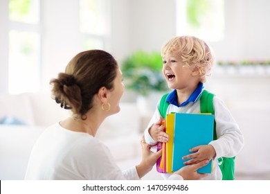 Child Going Back To School. Mother And Kid Getting Ready For First School Day After Vacation. Little Boy And Mom Going To Kindergarten Or Preschool. Student Packing Books, Apple And Lunch In Backpack.