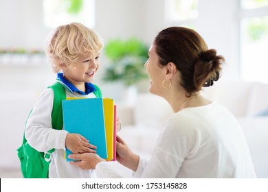 Child Going Back To School. Mother And Kid Getting Ready For First School Day After Vacation. Little Boy And Mom Going To Kindergarten Or Preschool. Student Packing Books, Apple And Lunch In Backpack.