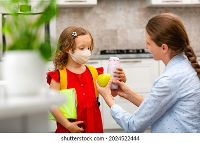 Child Going Back To School. Mother And Kid Getting Ready For First School Day After Vacation. Little Girl And Mom Going To Kindergarten Or Preschool. Student Holding Books, Apple And Lunch