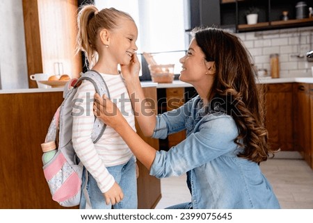 The child is going back to school. Mother and kid getting ready for the first school day. Little girl and mom going to school