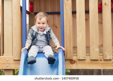 Child Going Down Slide On Backyard Cubby