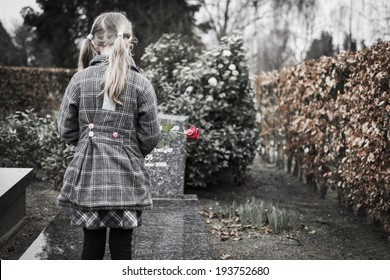 Child At Graveyard Grieving For Loss Of Family Or Friend