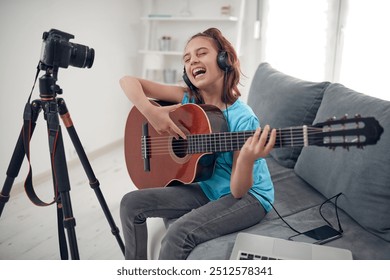 Child guitarist making video lessons and tutorials for internet vlog website classes. - Powered by Shutterstock