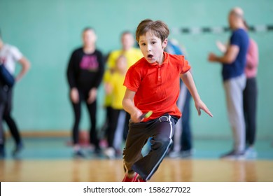 Child In The Gym. A Schoolboy In A Physical Education Lesson. Relay Race In Elementary School. The Boy Goes In For Sports. Children's Training. Sports Day.