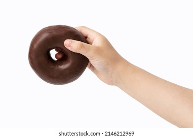 Child hand holding chocolate donut on white background.Banner with copy space.