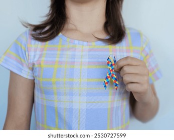 Child hand holding colorful heart concept. World autism awareness day. Sensory integration for children with autism - Powered by Shutterstock