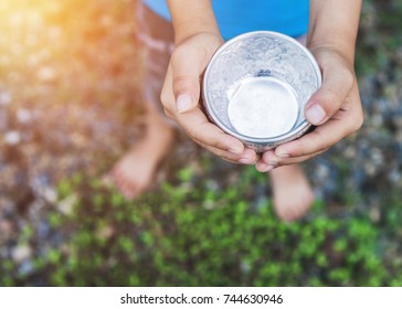 Child Hand Holding A  Cup And Seeking For Help, Charity Or Love Concept