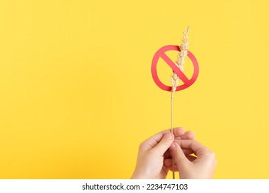 Child hand holding gluten free symbol. Celiac background  - Shutterstock ID 2234747103