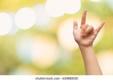 Child Hand With Hand Language For I Love You With Blurred Green Bokeh Background.