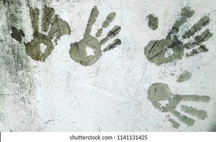 Child Hand Marks On Old White Wall