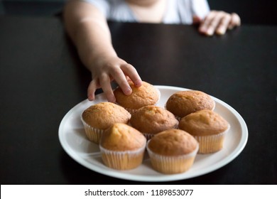 Child Hand Taking Muffins On Table Close Up, Hungry Preschool Little Girl Eager To Eat Cake While Parent Not Watching, Kid Addiction To Sweets, Secretly Stretching Hand, Not Allowed To Take