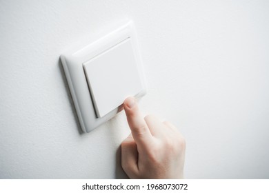 Child Hand Turning On Light Switch From Below - Prevent Child Hazard Concept