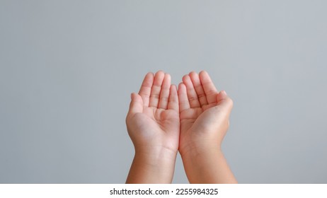 child hand. two hand empty for concept in give, help and pray isolated on grey background. - Powered by Shutterstock