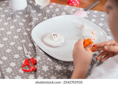 Child hands decorating "melting snowman" festive Christmas or Hanukkah cookies - Powered by Shutterstock