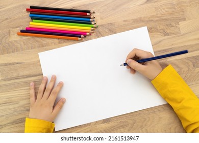 Child hands drawing with pencil on white paper, top view. Kids painting mock up. - Shutterstock ID 2161513947