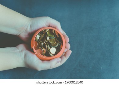  Child hands holding money jar. Donation,saving,charity ,family finance plan concept.Superannuation