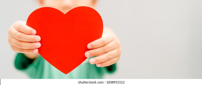 Child Hands Holding Red Heart For Share Donate.Health Care Pediatric.family Insurance.World Heart Day, World Health Day,CSR Responsibility, Adoption Foster Kids.Worship With Faith.Banner Background.