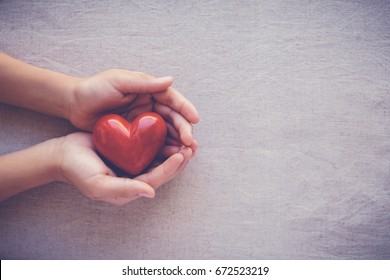 Child Hands Holding Red Heart, Health Care, Love And Family Concept, World Heart Day, Praying Concept