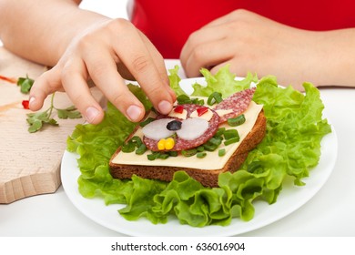 Child Hands Making A Funny Creative Sandwich - Closeup