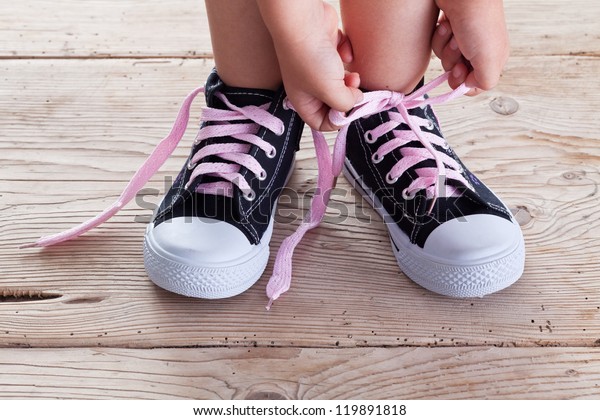 Child Hands Tie Shoe Laces On Stock 