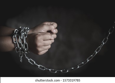 Child Hands Tied Up With Chain , Human Trafficking, Violence Against Children, Human Rights Violations Concept