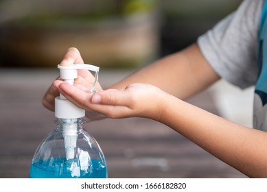 Child Hands Using Wash Hand Sanitizer Gel Pump Dispenser, Selected Focus