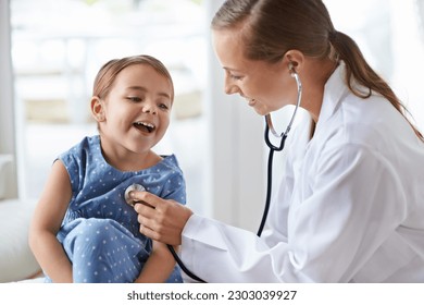 Child, happy pediatrician and stethoscope for healthcare consulting, check lungs and listening to heartbeat. Woman, medical doctor and girl kid in clinic for chest assessment, analysis and checkup - Powered by Shutterstock