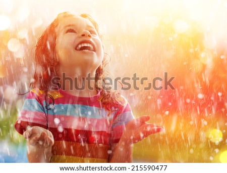 the child is happy with the rain