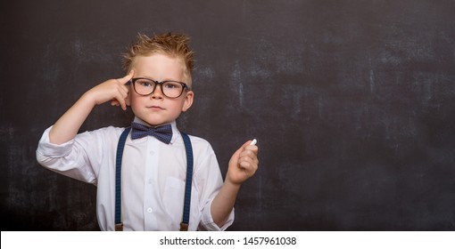 Child has bright idea. Boy with finger on head.  - Powered by Shutterstock