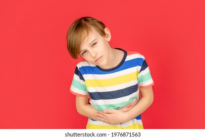 Child Has Stomachache With Food Poisoning. Child Holding Hands On Belly. Stomach Pain. Teen Boy With Stomachache. Child Having Terrible Pain In Stomach. Diarrhea Or Gastroenteritis Health Problem.