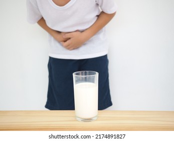 Child Has An Upset Stomach, Bloating Due To Lactose Intolerance. Dairy Intolerant Person. Health Care Concept. Closeup Photo, Blurred.