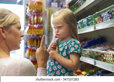 Child Having Argument With Mother At Candy Counter
