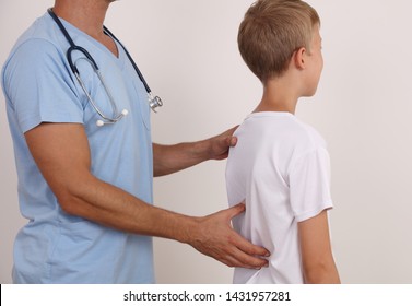 Child Having Chiropractic Back Adjustment. Osteopathy, Physiotherapy, Kinesiology. Bad Posture Correction