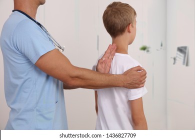 Child Having Chiropractic Back Adjustment. Osteopathy, Physiotherapy, Kinesiology. Bad Posture Correction