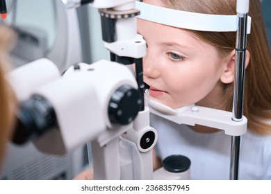 Child having his eyes checked with ophthalmic equipment - Powered by Shutterstock