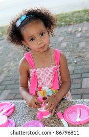 Child Having A Tea Party