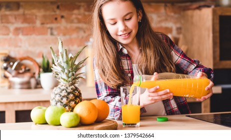 Child Health And Development. Vitamin Orange Juice For Balanced Nutrition. Little Girl Pouring Fresh Fruit Drink From Bottle.