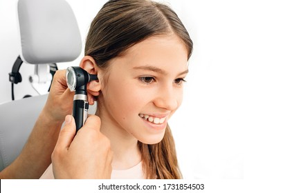 Child Hearing Exam. Diagnosis Of Impairment And Hearing Testing In Children. Girl During An Ear Checkup With An Audiologist