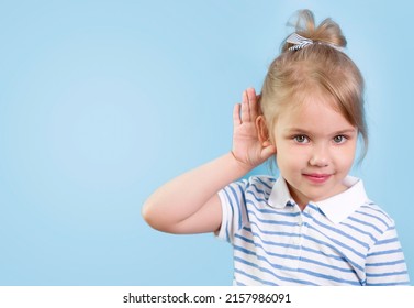 Child With Hearing Problem On Blue Background Empty Copy Space. Hearing Loss, Symptoms And Treatment Concept. Caucasian Kid Portrait.