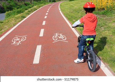 Child With Helmet On Bicycle Path