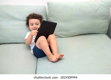 Child With Her Grandparents Video Chat. Happy Little Preschool Boy Is Studying Connected With The Teacher Online, Using Tablet. Homeschool, Distance Learning, Video Call At Home.