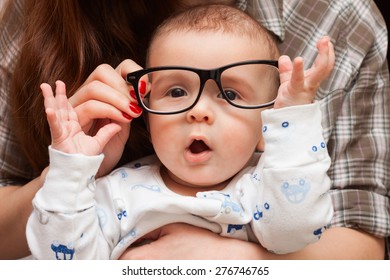 A Child In Her Mother's Glasses. Funny Baby In Glasses