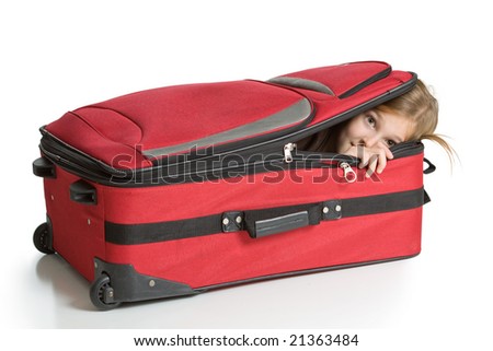 Child hiding inside a red suitcase. Isolated on a white background.
