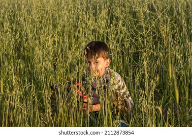 Child Hiding In The Tall Grass.