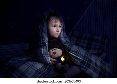 Child hiding under the blanket - Powered by Shutterstock